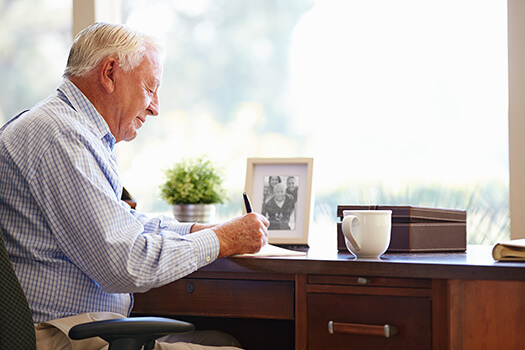 Elderly-Man-at-Desk-Writing